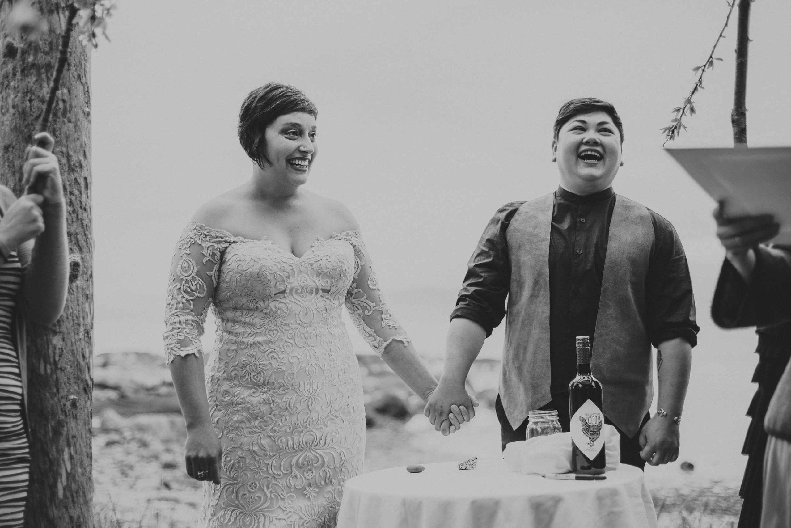 lgbtq couple holding hands during their wedding ceremony