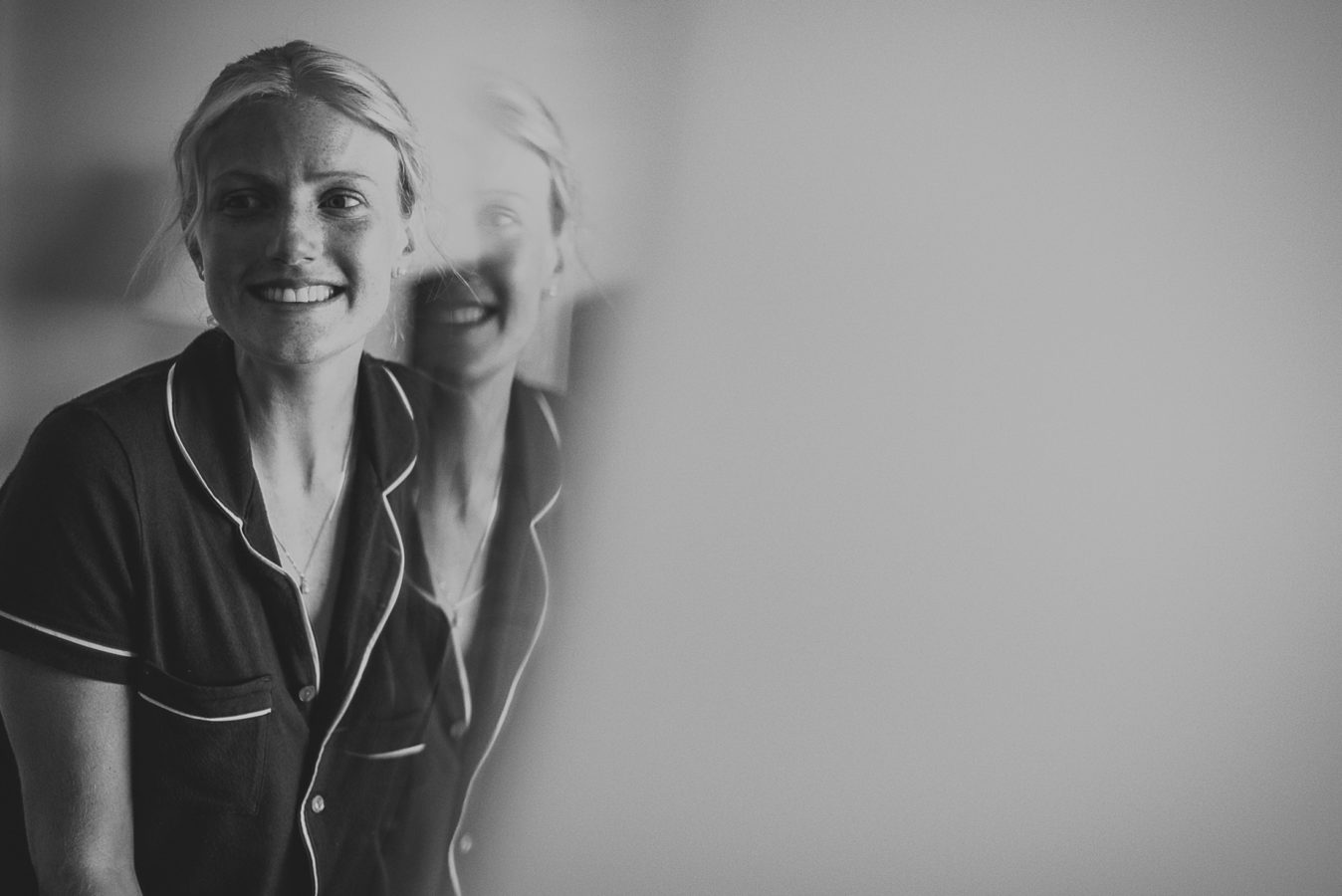 double reflection of woman in a mirror smiling