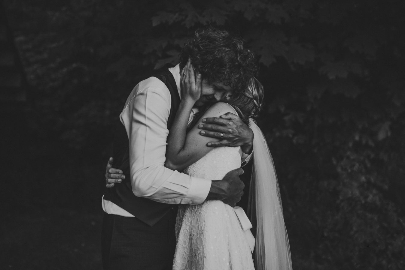 bride and groom hugging tightly on their wedding day