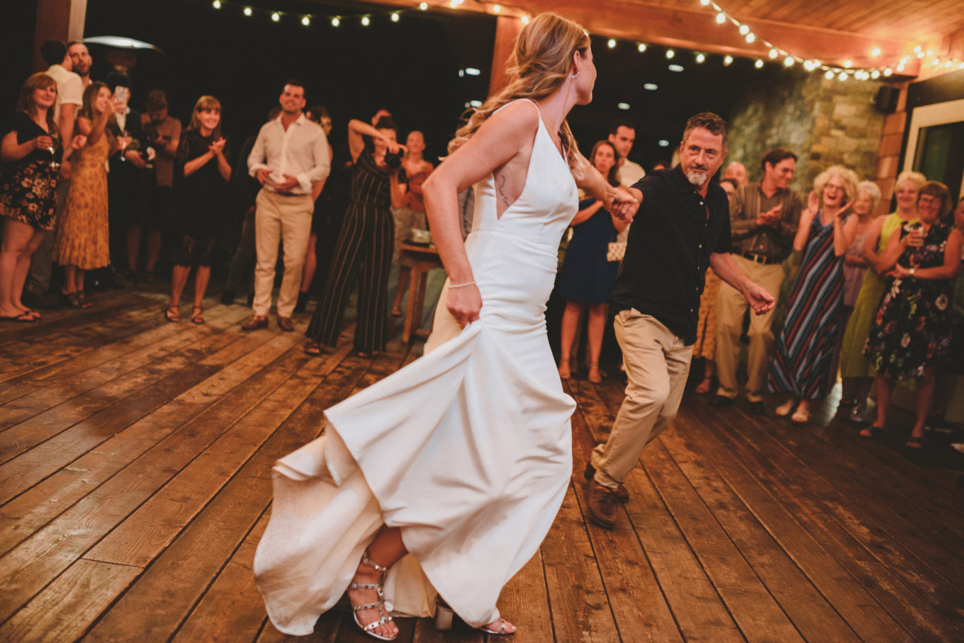 bride and her father dancing with their arms stretched out towards each other on her wedding day