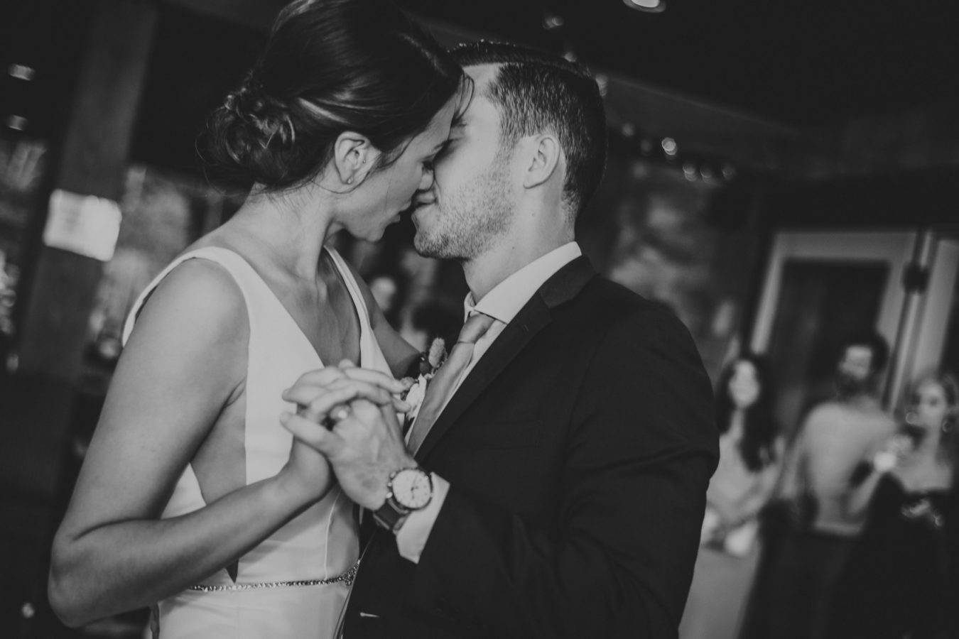 intimate moment of bride and groom kissing during their first dance