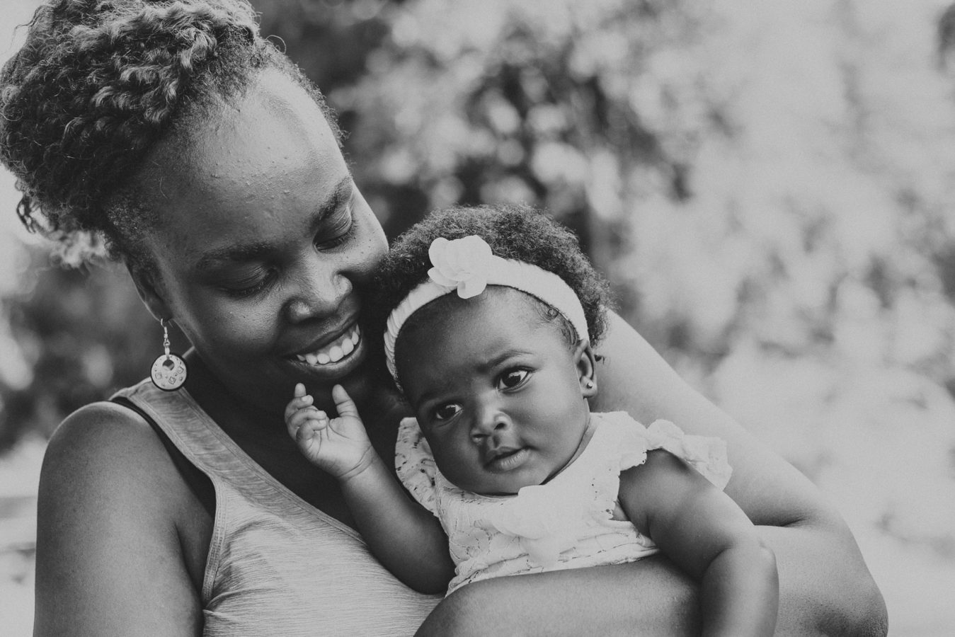 beautiful Black woman snuggling her baby girl