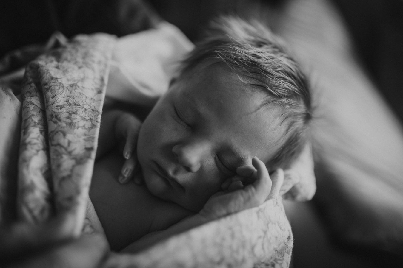 close up of a newborn baby swaddled