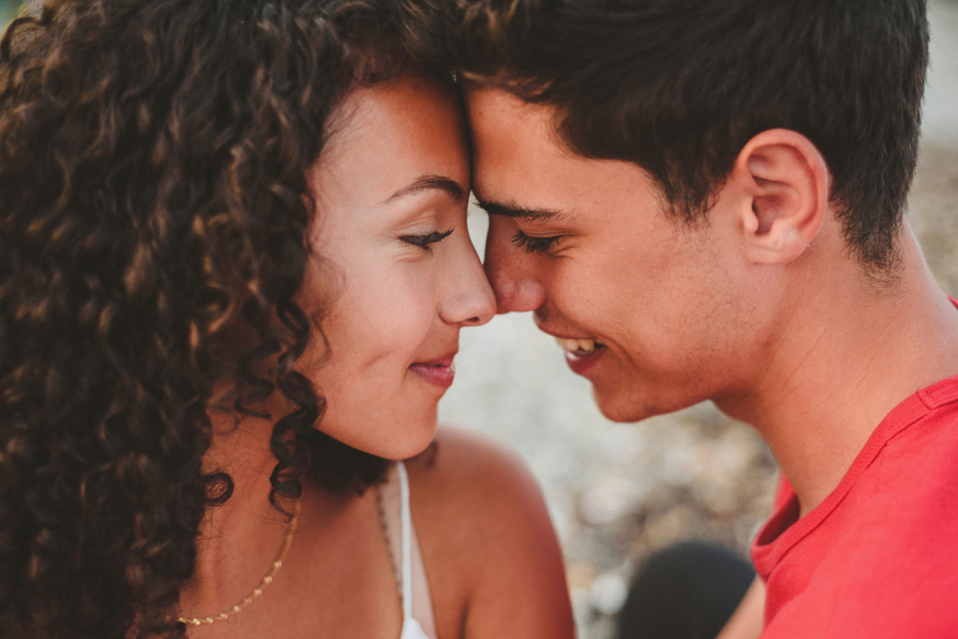 close up of mixed race young couple with their foreheads pressed together
