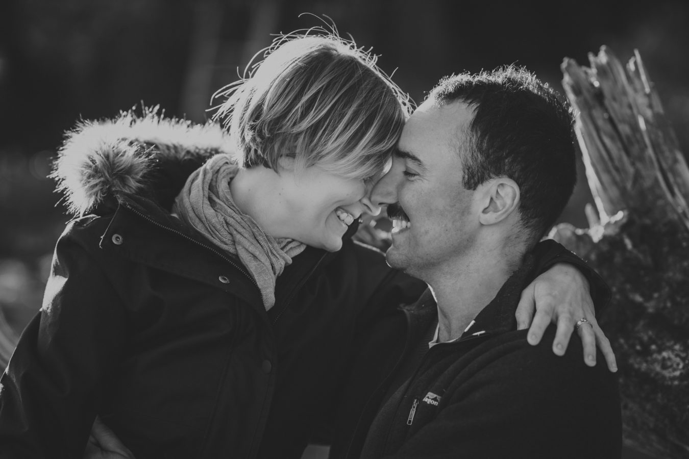 close up of a man and woman laughing with their foreheads together
