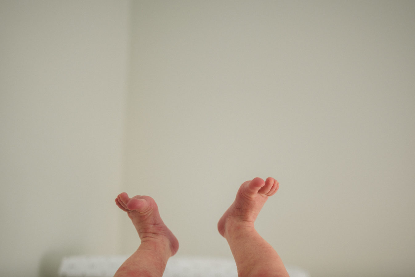 close up of a baby's feet kicking in the air