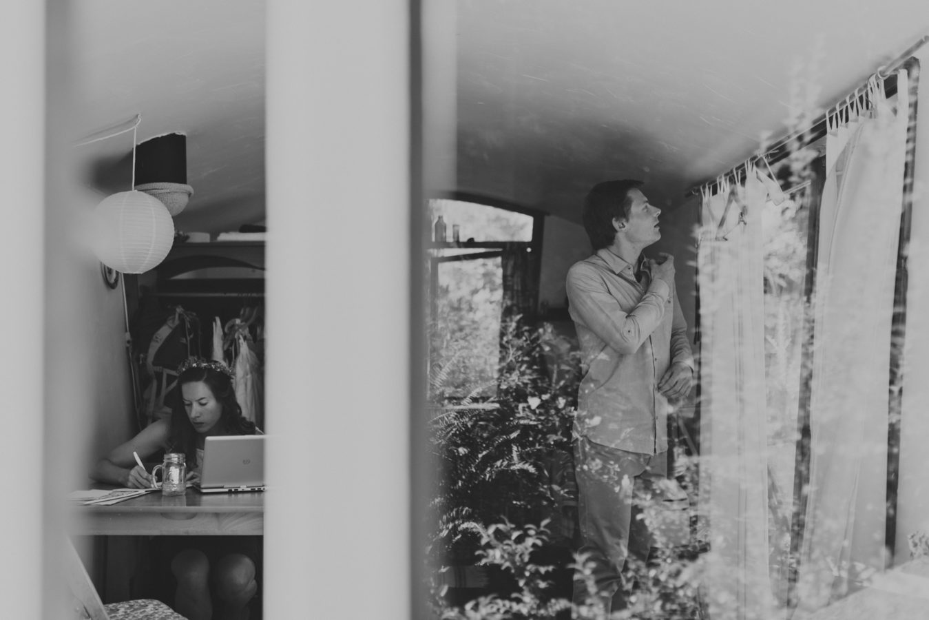 looking through a window at a bride and groom getting ready for their elopement