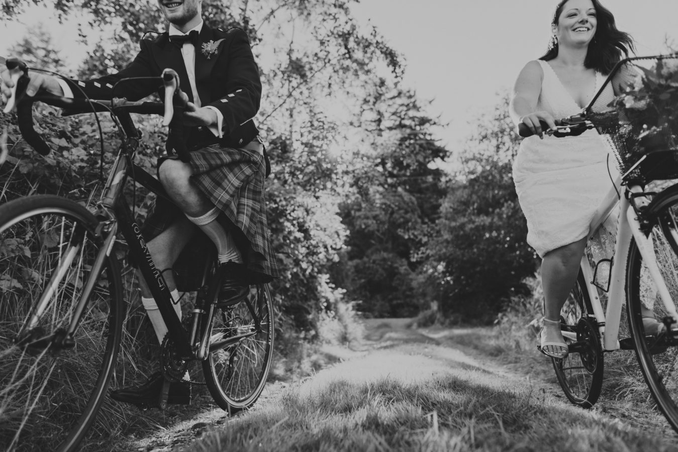 bride and groom riding their bikes towards the camera