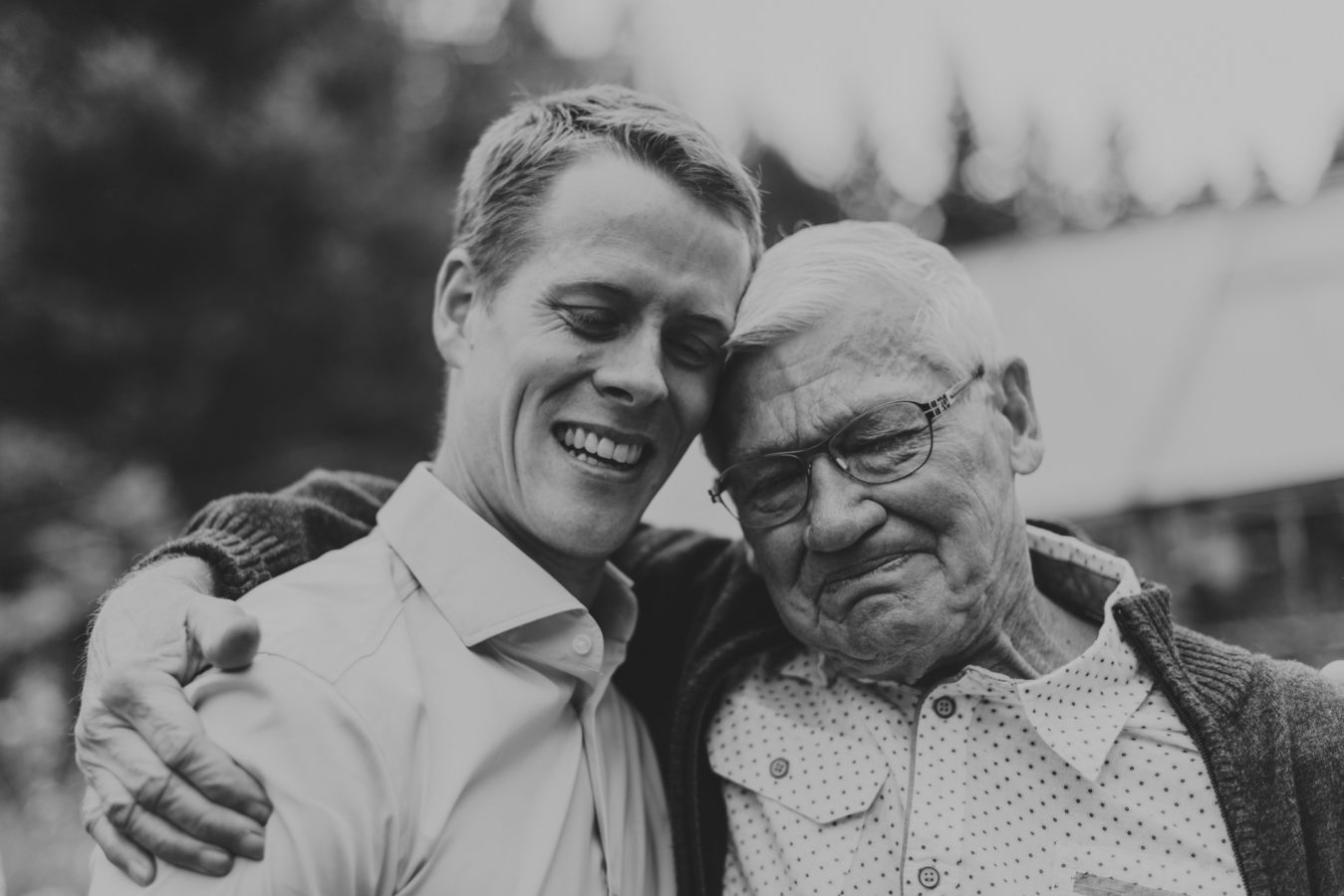 grandfather emotionally hugging his grandson on his wedding day