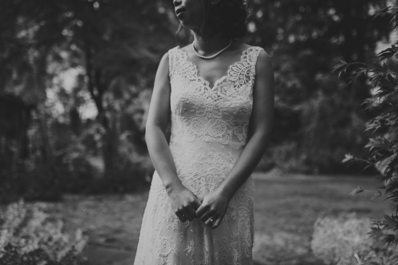 close up of a bride standing in the forest on her wedding day